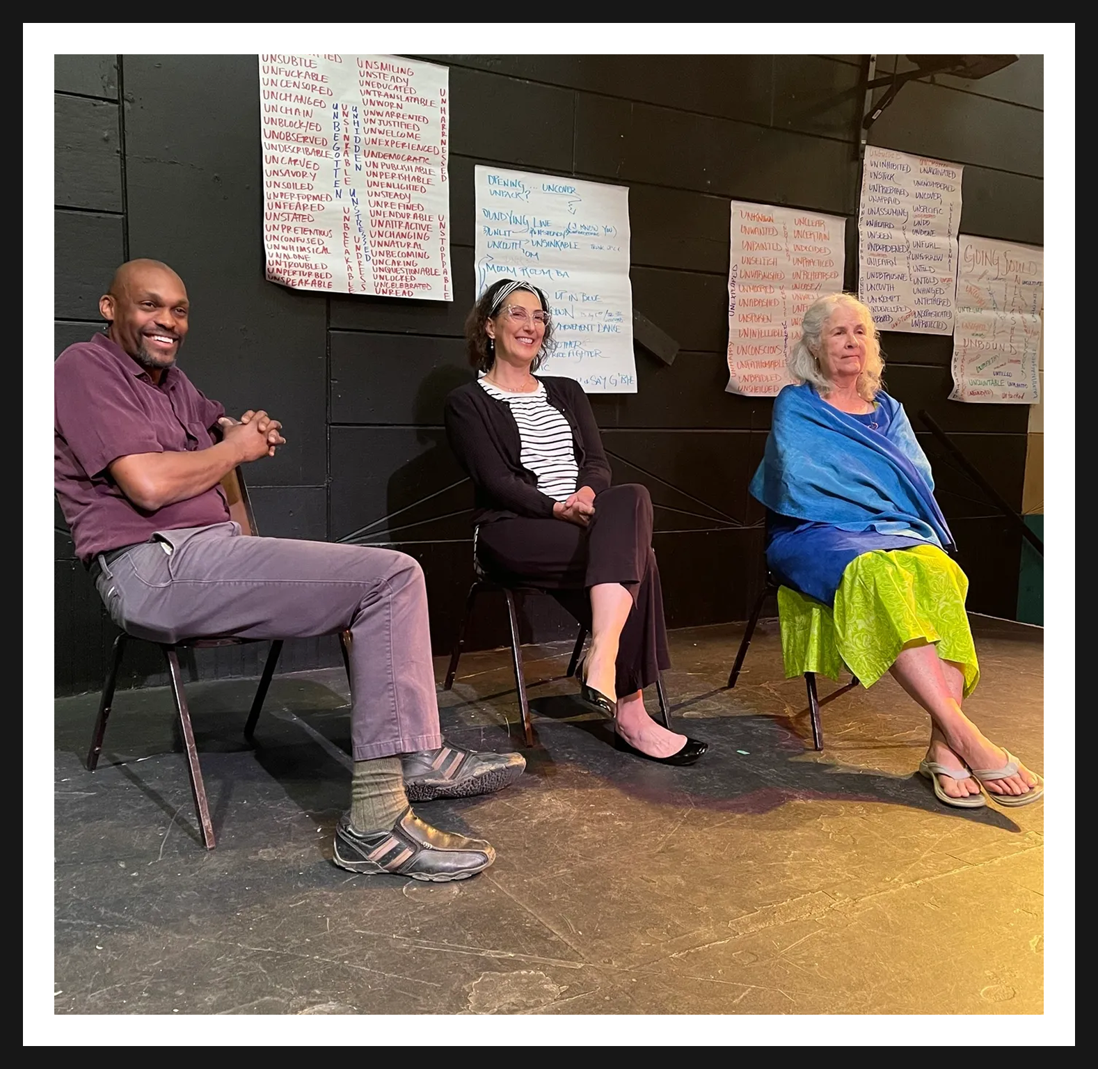 Group discussion with three seated individuals.