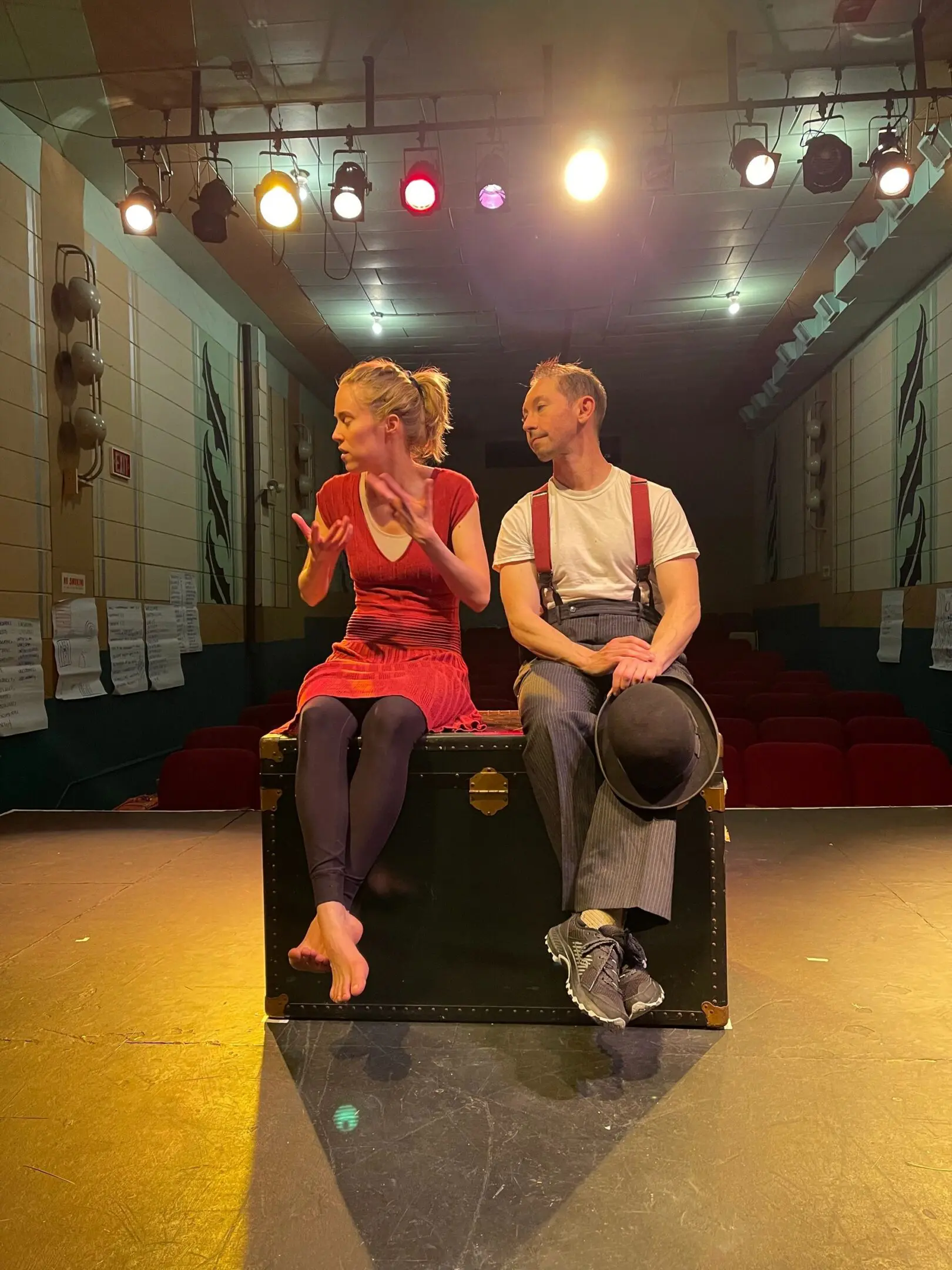 Duo in theater setting, colorful spotlight