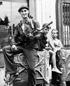 Smiling soldier sitting with children