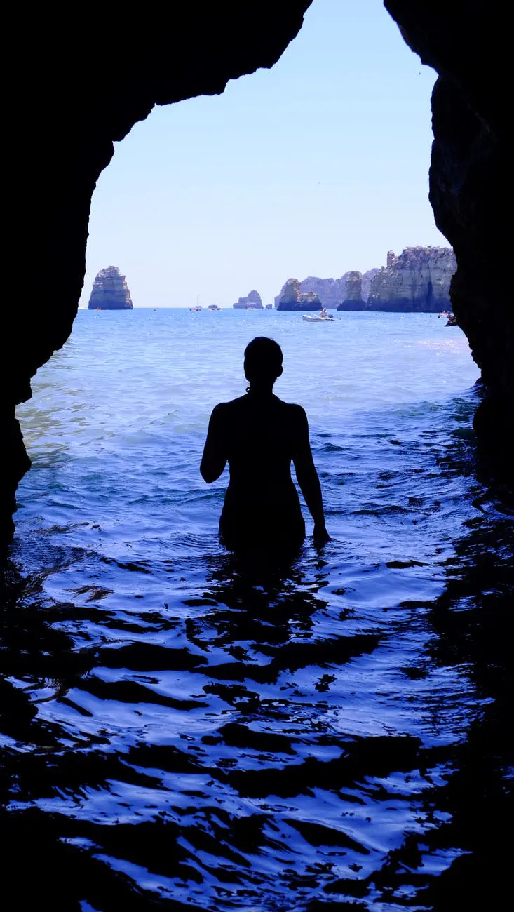 Cave view with person and distant ocean