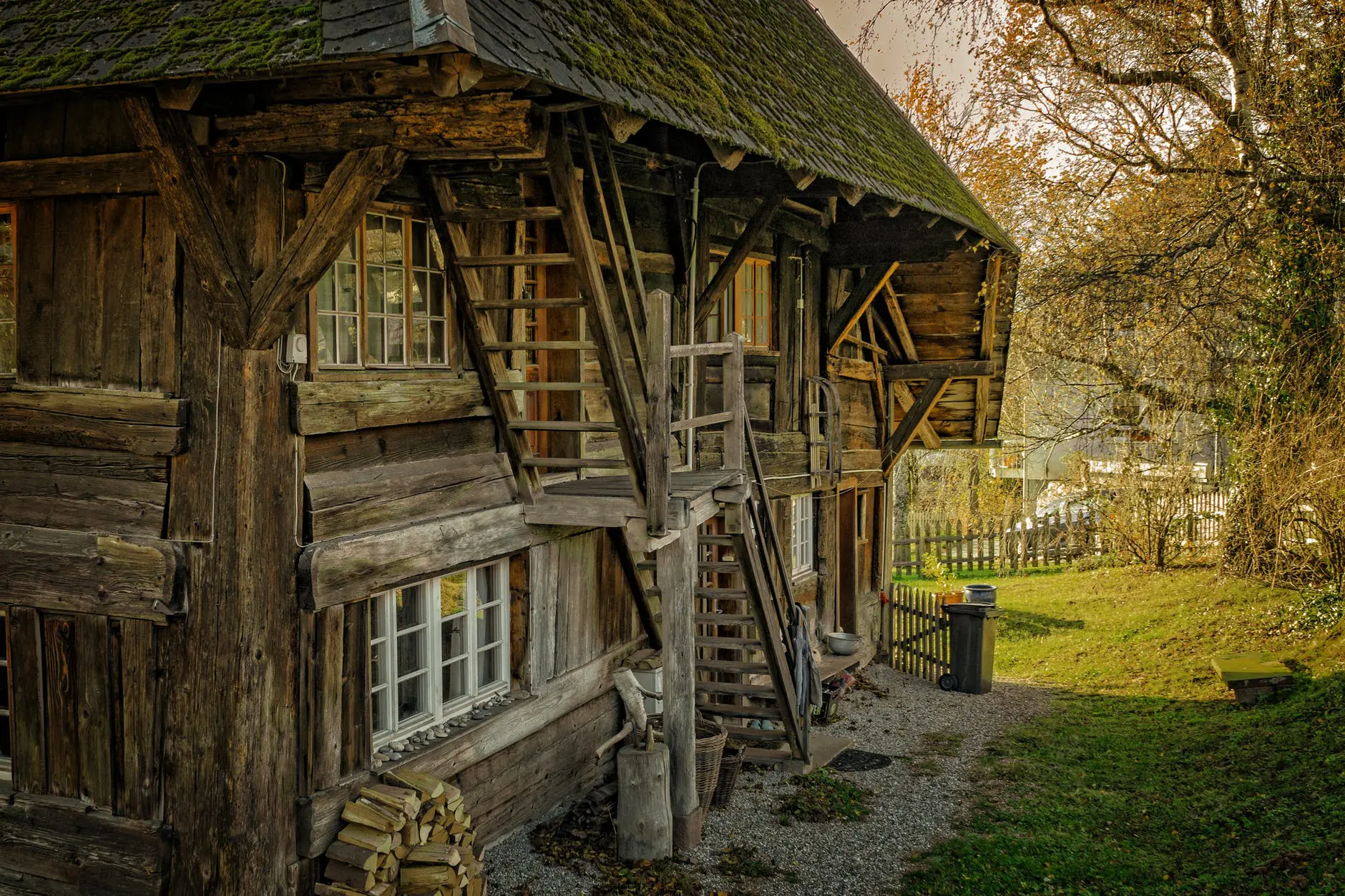 Rustic wooden house with autumn foliage