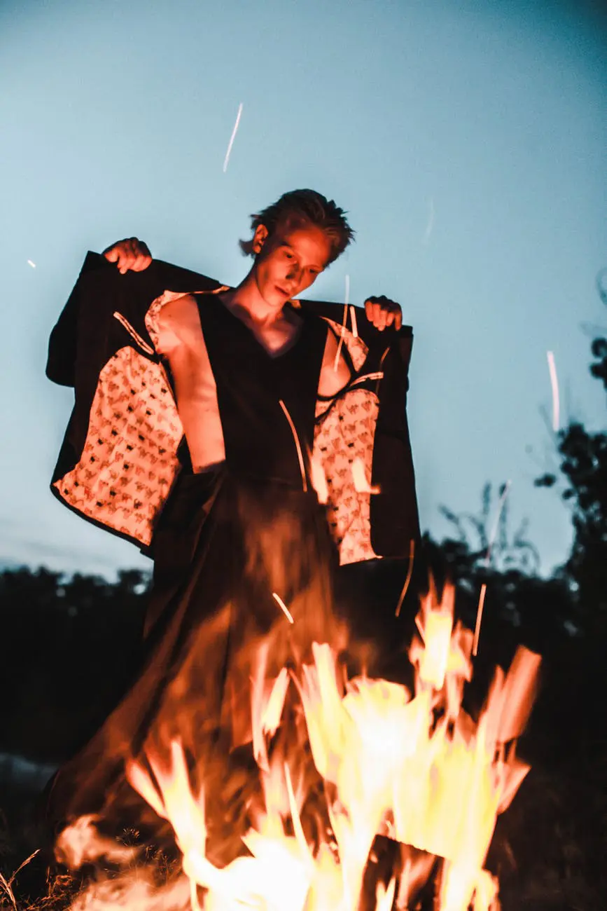 Person standing confidently by a fire