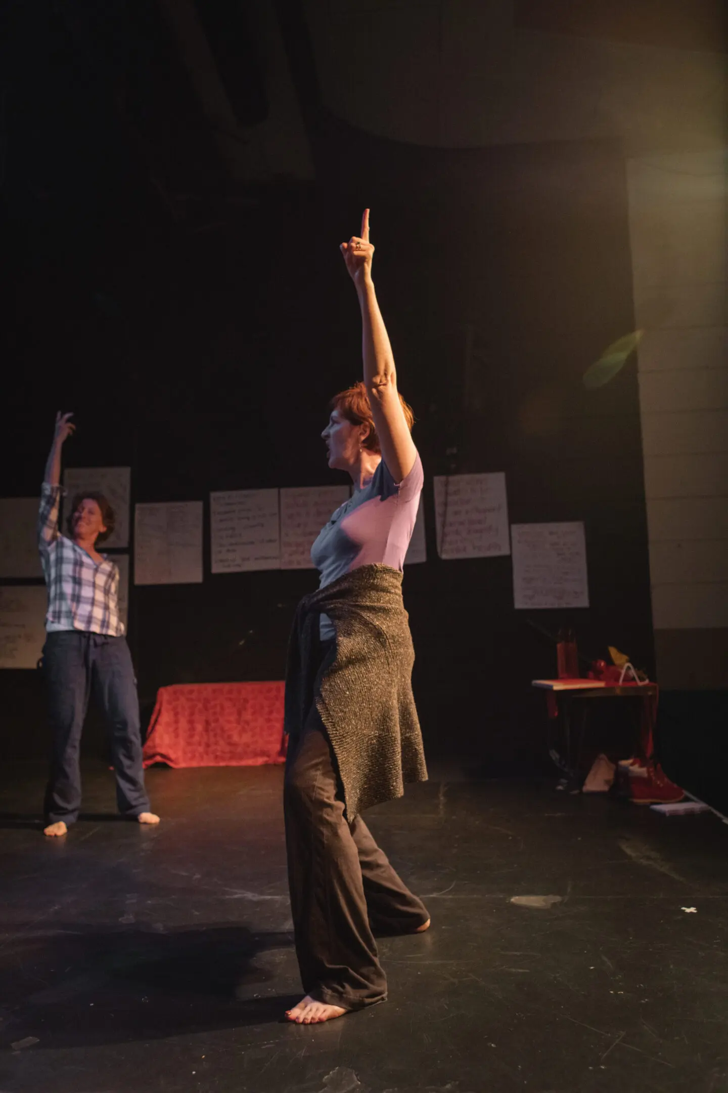 Two people dancing on stage, expressive poses.