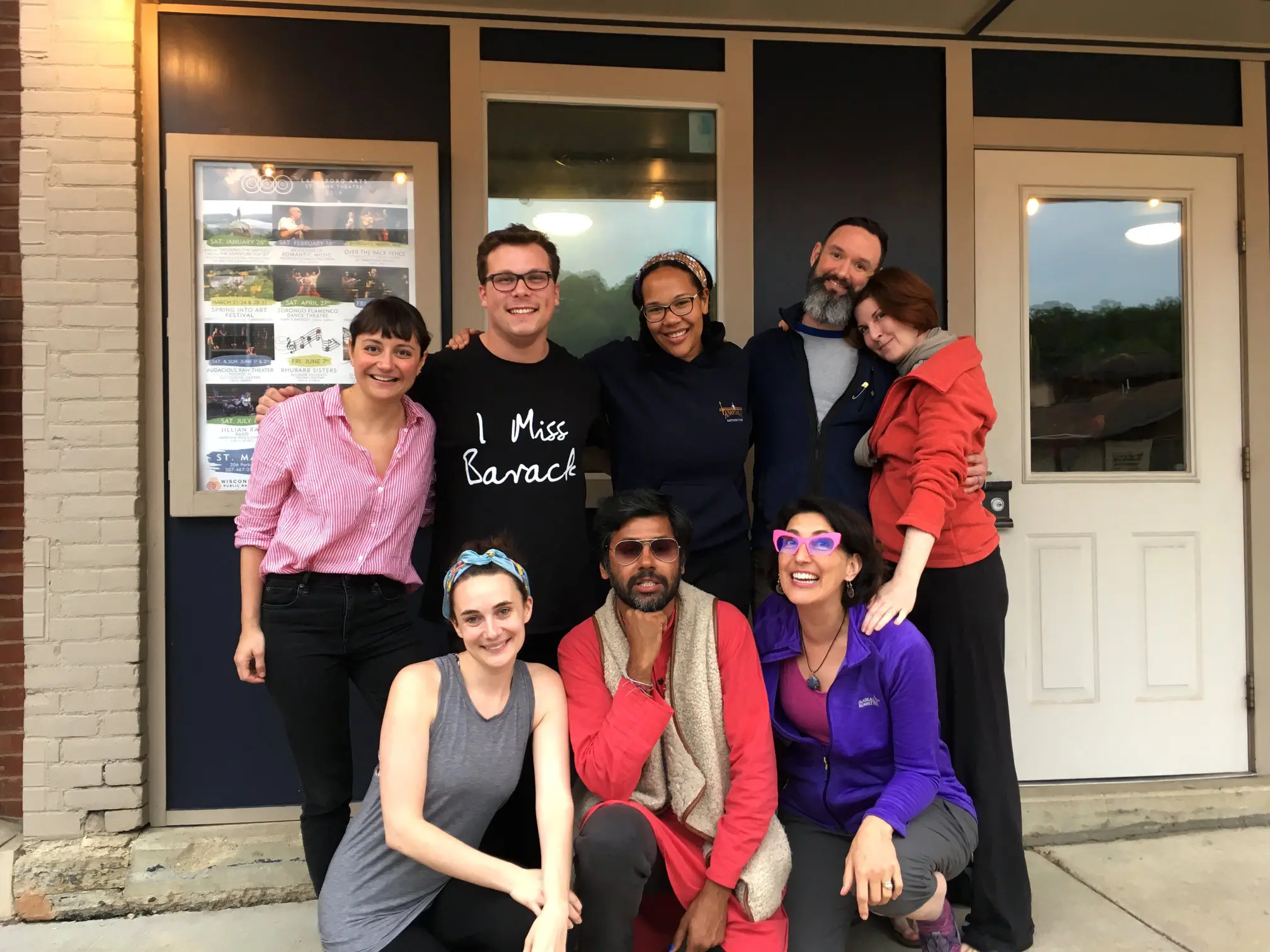 Group of people smiling outside a building.
