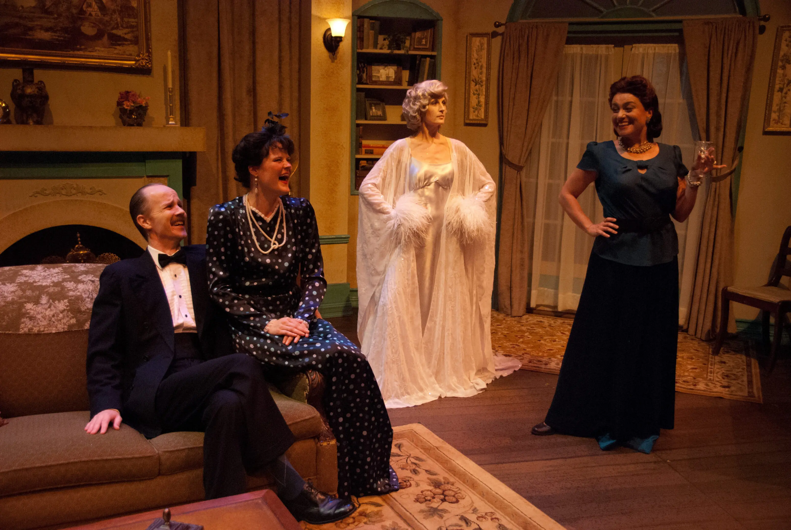Four actors performing in a living room.