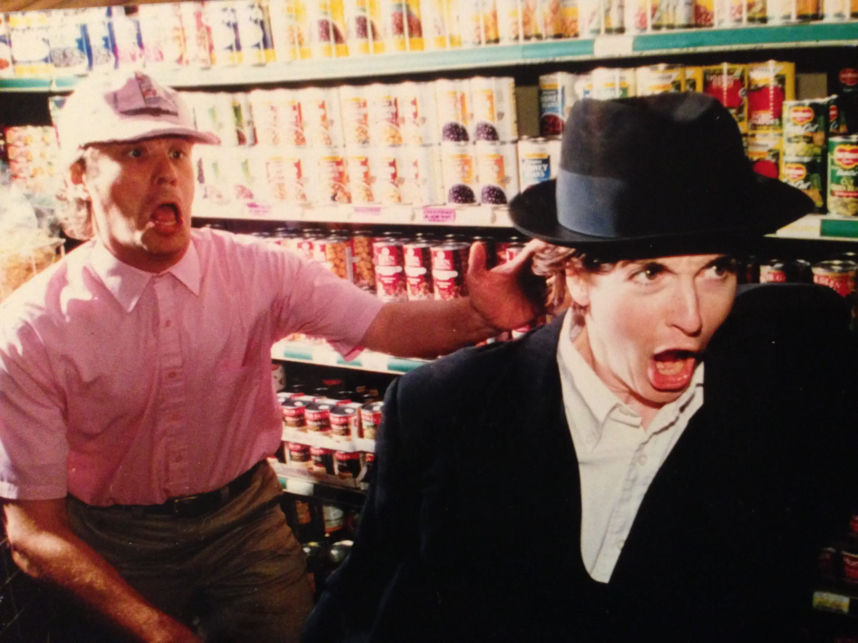 Two surprised men in a grocery store.