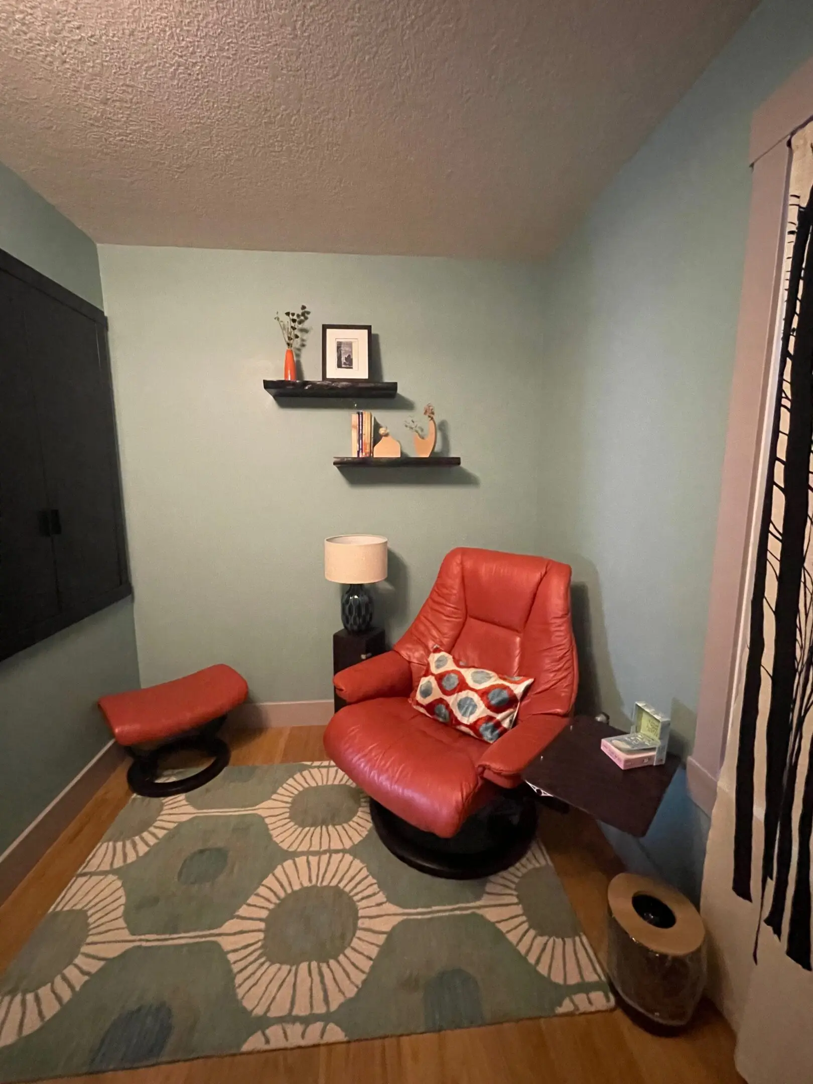 Red chair in cozy reading nook.