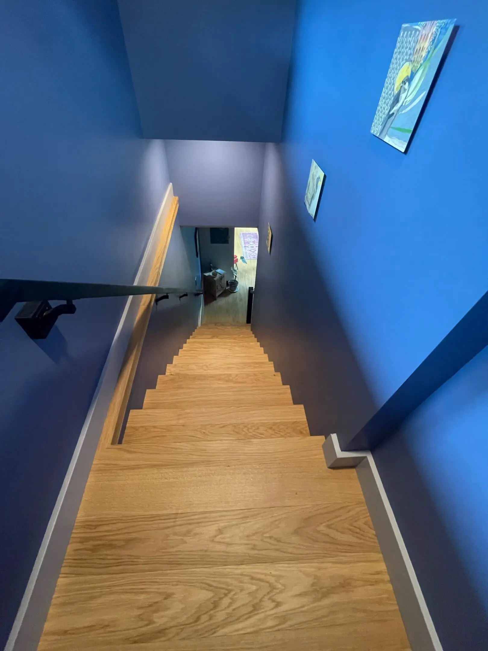 Wooden staircase with blue painted walls.