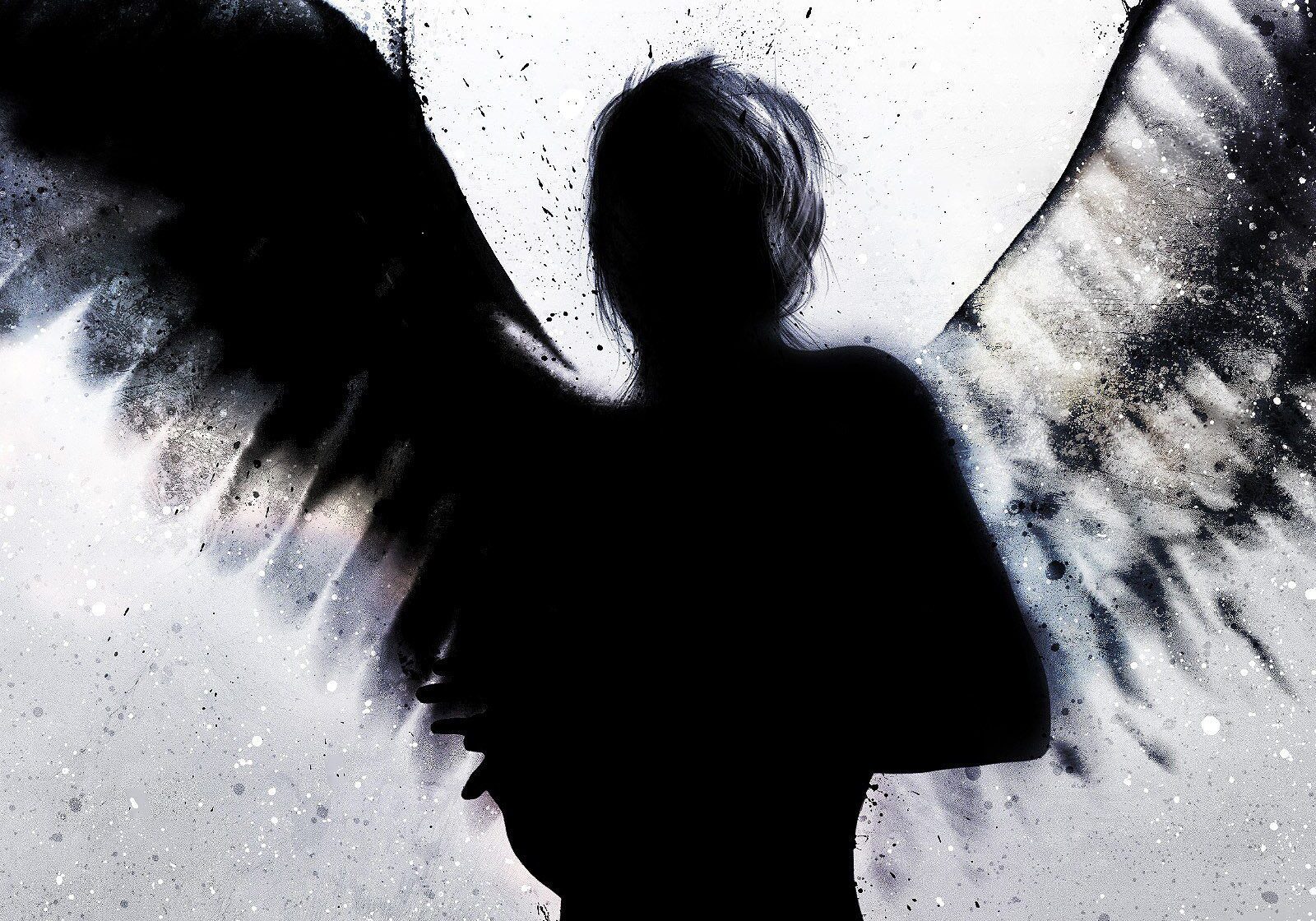 Silhouette of angel with wings spread