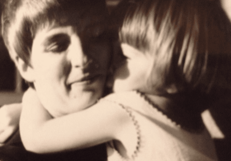 Child hugging adult affectionately