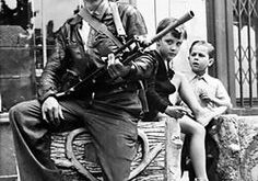 Smiling soldier sitting with children