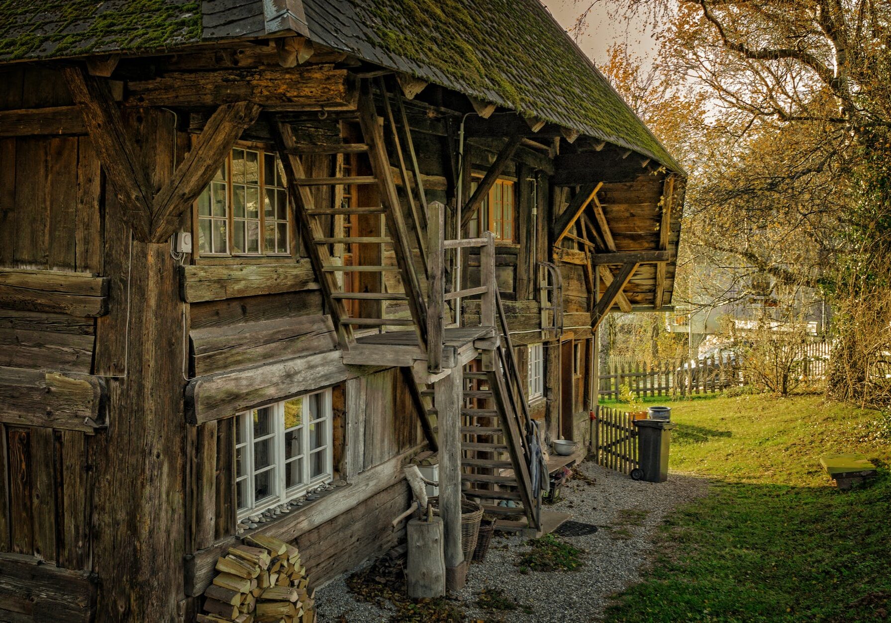 Rustic wooden house with autumn foliage